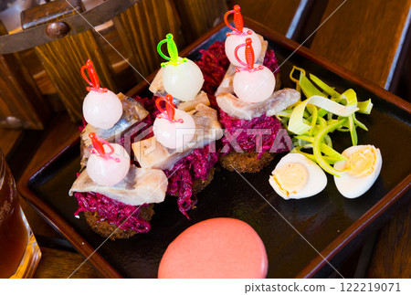 Appetizer of pickled herring with beets Appetizer of pickled herring with beets 122219071