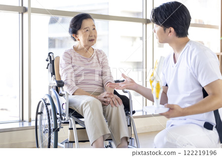 Medical: Senior woman receiving a medical examination from a physical therapist 122219196