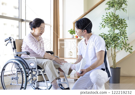 Medical: Senior woman receiving a medical examination from a physical therapist 122219232