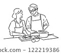 Men and women having a conversation while cooking 122219386