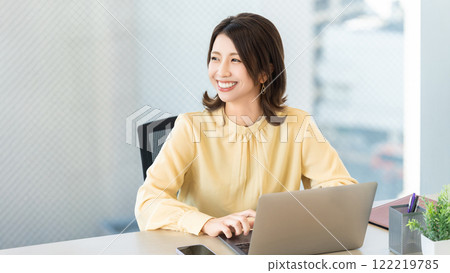 Smiling woman/businesswoman doing desk work Smiling woman/businesswoman doing desk work 122219785