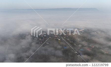 Aerial view of small village in Pa Daet district in Chiang Rai province of Thailand covered with fog in winter season.  122219799