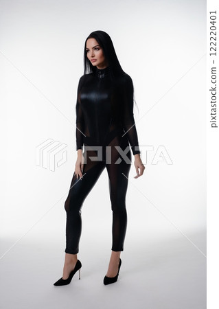 Elegant woman in black lingerie poses confidently in studio setting 122220401