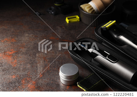Men's shaving tools in case and cosmetic jar on dark background, space for text Men's shaving tools in case and cosmetic jar on dark background, space for text 122220481