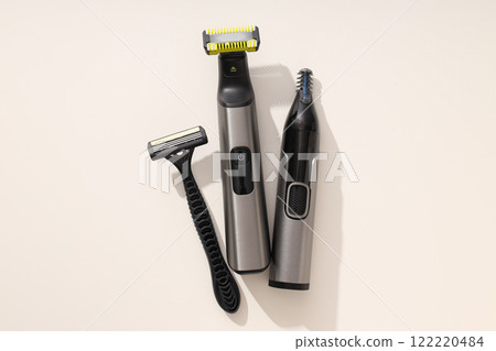 Men's electric and disposable razors on light background, top view Men's electric and disposable razors on light background, top view 122220484