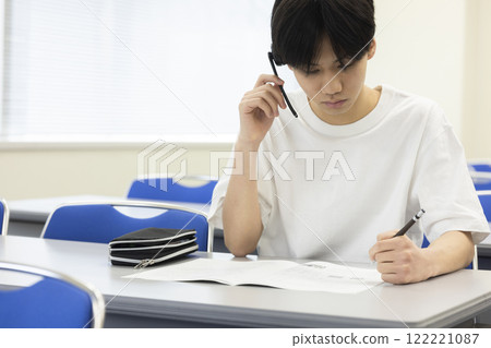 Students taking a test wearing headsets Students taking a test wearing headsets 122221087
