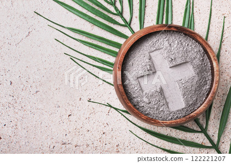 Ash wednesday background with cross in ashes and palm leaf 122221207