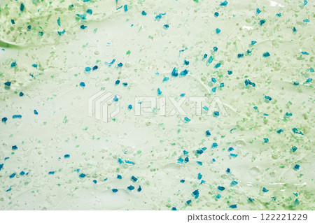 Abstract green and blue microplastic particles on light background Abstract green and blue microplastic particles on light background 122221229