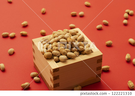 Japanese event. Setsubun. Soybeans for bean-throwing placed on a red background. Japanese event. Setsubun. Soybeans for bean-throwing placed on a red background. 122221310