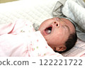 Baby yawning in bed 122221722
