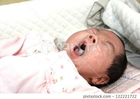 Baby yawning in bed 122221722