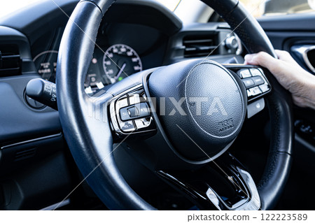 Driver's steering wheel and driver's hands Driver's steering wheel and driver's hands 122223589