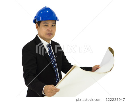 Businessman in a black suit wearing a blue construction hat, checking the construction drawing of real estate project. Portrait on white background with studio light. Isolated Businessman in a black suit wearing a blue construction hat, checking the construction drawing of real estate project. Portrait on white background with studio light. Isolated 122223947
