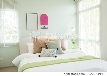 Modern bedroom with green and pink pillows on bed. Stylish bedroom interior design. Modern bedroom with green and pink pillows on bed. Stylish bedroom interior design. 122224990
