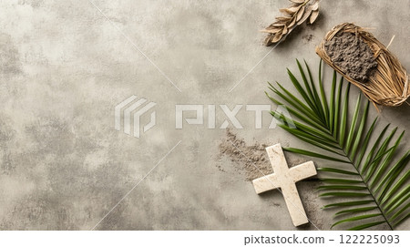 White cross is on a grey background with a palm leaf and some sand 122225093