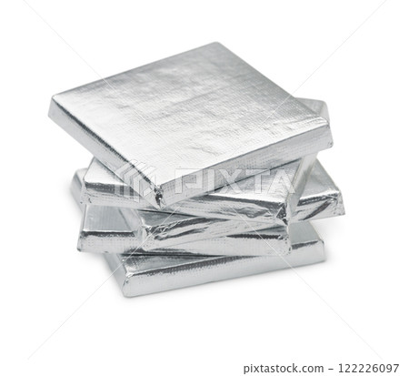 Stack of silver foil wrapped square chocolate bars 122226097