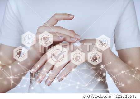 Girl smearing cream on her hands. Girl smearing cream on her hands. 122226582