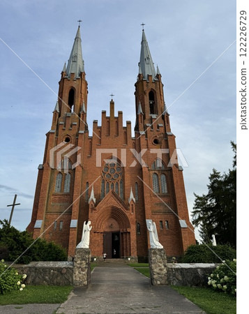 Gothic Revival Church With Twin Spires and Angel Statues 122226729