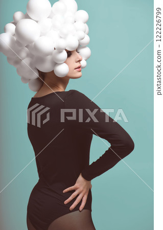 Surreal Beauty with White Spheres Headpiece in Blue Background Surreal Beauty with White Spheres Headpiece in Blue Background 122226799