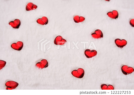 Abstract textured background with hearts on a white plush background. Abstract textured background with hearts on a white plush background. 122227253