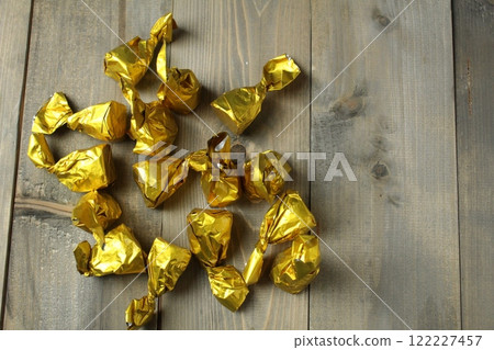 Scattering of candies in a wrapper on a gray background, top view, upper angle. Healthy candies Scattering of candies in a wrapper on a gray background, top view, upper angle. Healthy candies 122227457