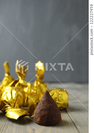Chocolate candy on a gray gold background vertical photo. Chocolate Candy Day. Festive atmosphere Chocolate candy on a gray gold background vertical photo. Chocolate Candy Day. Festive atmosphere 122227459