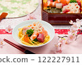Chirashi sushi served on a tiered box and small plate 122227911