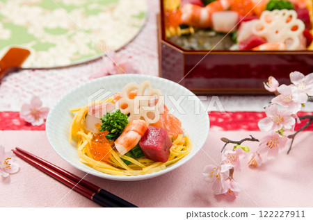 Chirashi sushi served on a tiered box and small plate 122227911