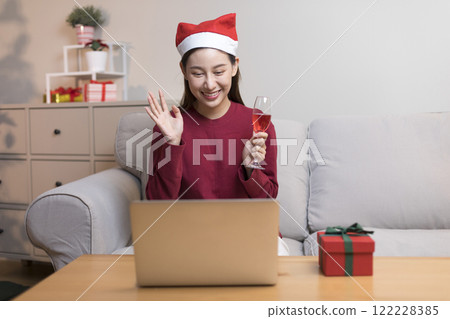 Asian pretty young woman greeting on video call during coronavirus, social distance, merry x'mas. 122228385