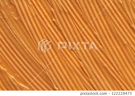 Smooth peanut butter texture with evenly spread creamy surface highlighting Smooth peanut butter texture with evenly spread creamy surface highlighting 122228473