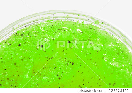 Vibrant green slime texture with black specks in close up for creative projects Vibrant green slime texture with black specks in close up for creative projects 122228555