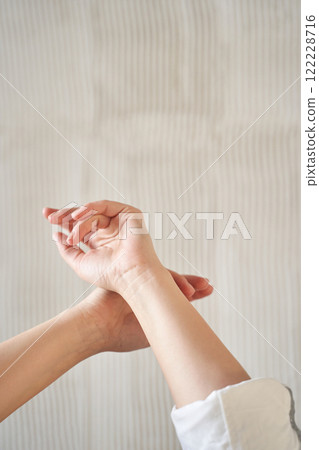 Close up of female hands in gentle pose against neutral background Close up of female hands in gentle pose against neutral background 122228716