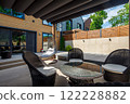 Backyard outdoor bbq zone with pergola, fireplace and hanging chair. Summer party place 122228882