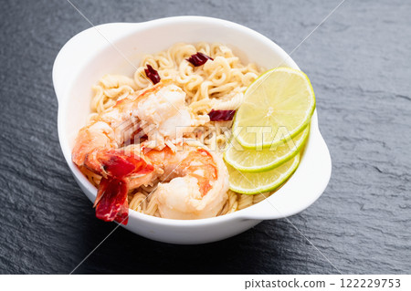 Tom yum soup with shrimps instant noodles and lime photography . Asian food . Top view 122229753