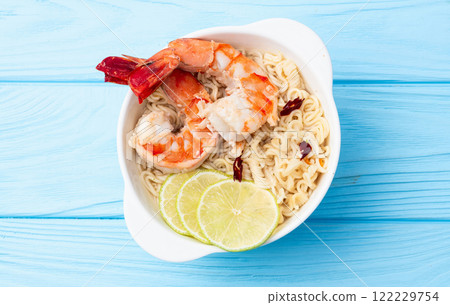 Tom yum soup with shrimps instant noodles and lime photography . Asian food . Top view 122229754