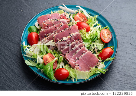Salad with raw tuna , sesame and cherry tomatoes photography . Top view Salad with raw tuna , sesame and cherry tomatoes photography . Top view 122229835
