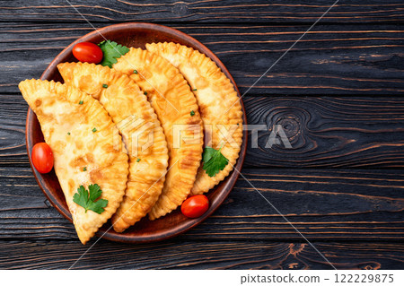 Snack chebureks. Pasties with meat photography . Top view Snack chebureks. Pasties with meat photography . Top view 122229875