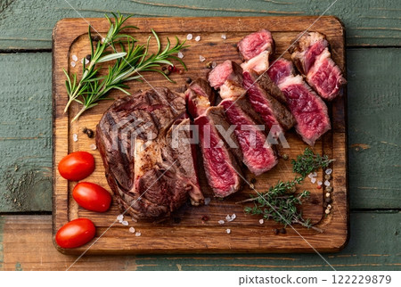 Ribeye grilled beef steak sliced . Rare doneness photography . Top view Ribeye grilled beef steak sliced . Rare doneness photography . Top view 122229879