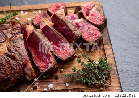 Ribeye grilled beef steak sliced . Rare doneness photography . Top view Ribeye grilled beef steak sliced . Rare doneness photography . Top view 122229881
