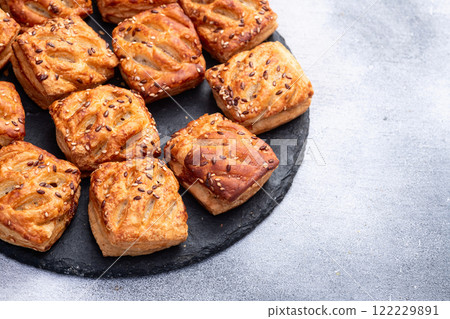 Flaky Pastries with Sesame Seeds on Slate 122229891