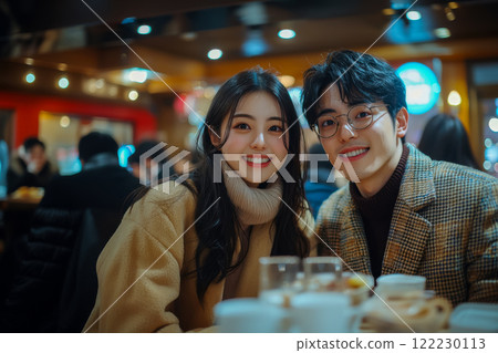 Dinner in a cafe on a date on Valentine's Day, a couple of young beautiful people posing on the background, copy space for concept 122230113