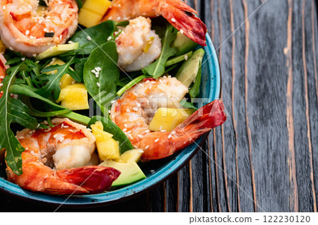 Salad with tiger shrimps , avocado and mango . Top view Salad with tiger shrimps , avocado and mango . Top view 122230120