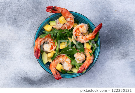 Salad with tiger shrimps , avocado and mango . Top view Salad with tiger shrimps , avocado and mango . Top view 122230121