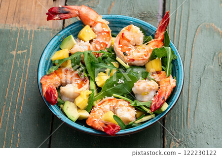 Salad with tiger shrimps , avocado and mango . Top view 122230122