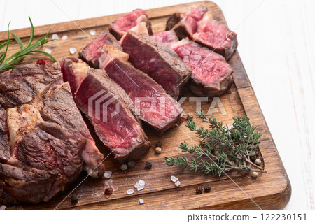 Ribeye grilled beef steak sliced . Rare doneness photography . Top view Ribeye grilled beef steak sliced . Rare doneness photography . Top view 122230151