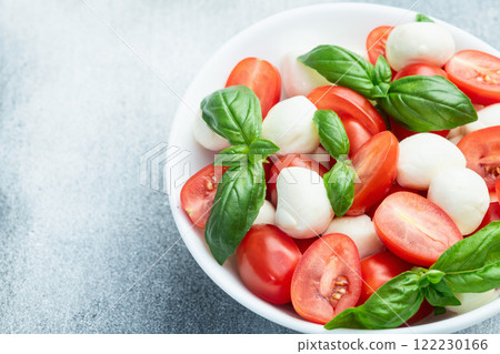 Basil leaves , cherry tomatoes and mozzarella cheese . In bowl food photography 122230166