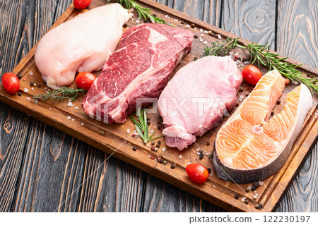 Mix of raw meat and fish . Salmon , beef , pork , chicken staek . Top view 122230197