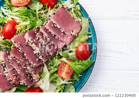 Salad with raw tuna , sesame and cherry tomatoes photography . Top view Salad with raw tuna , sesame and cherry tomatoes photography . Top view 122230400