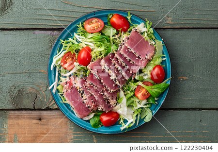 Salad with raw tuna , sesame and cherry tomatoes photography . Top view Salad with raw tuna , sesame and cherry tomatoes photography . Top view 122230404