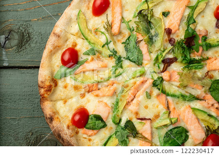 Italian pizza with avocado salmon tomatoes and mozzarella photography. top view Italian pizza with avocado salmon tomatoes and mozzarella photography. top view 122230417